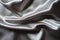 Crumpled glossy gray polyester satin fabric