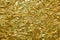 Crumpled, golden metallic paper texture background