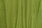 Crumpled green textured cotton fabric. Ribbed texture. Seamless background