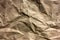 Crumpled kraft paper texture. Abstract rumpled brown paper background.