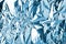 Crumpled light blue foil shining texture background, bright shiny cold icy design, metallic glitter surface