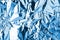 Crumpled light blue foil shining texture background, bright shiny cold icy design, metallic glitter surface