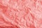 Crumpled Paper Background Texture in Coral