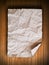 Crumpled paper on wood wall