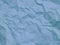 Crumpled pastel blue paper texture background