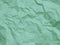 Crumpled pastel mint paper texture background