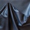 Crumpled piece of black cattle genuine leather