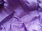 Crumpled purple satin cloth