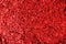 Crumpled red foil shining texture background, bright shiny festive design, metallic glitter surface