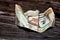 Crumpled Saudi Arabia money of 10 SAR ten riyals isolated on wooden background, wrinkled 10 Saudi Riyals cash bill banknote