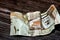 Crumpled Saudi Arabia money of 10 SAR ten riyals isolated on wooden background, wrinkled 10 Saudi Riyals cash bill banknote