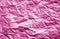 Crumpled sheet of paper with blur effect in pink color