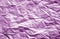 Crumpled sheet of paper with blur effect in purple color