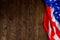 crumpled usa flag on flat textured wooden surface background