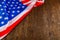 crumpled usa flag on flat textured wooden surface background