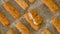 Crunchy breaded fish sticks made from wild caught Alaskan Pollock close-up on a baking pan, just from the oven