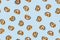 Crunchy Brezeln or salted Pretzel trendy pattern on blue background. Top view, flat lay. Traditional snack for Octoberfest