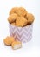 Crunchy chicken popcorn bites in kids paper cup for fast food meals on white background