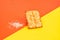 Crunchy crackers or cookies, sesame slices on a creative red and yellow background