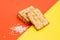 Crunchy crackers or cookies, sesame slices on a creative red and yellow background