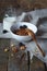 Crunchy honey granola bowl with flax seeds, cranberries and a bottle of milk on a table, healthy and fiber food, selective focus