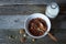 Crunchy honey granola bowl with flax seeds, cranberries and a bottle of milk on a table, healthy and fiber food, selective focus