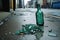 crushed glass bottle on gritty urban sidewalk