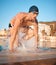 He crushed that lap. a handsome young male athlete swimming in an olympic-sized pool.