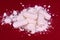 Crushed pills on a red background. Drug abuse. Close-up