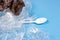 Crushed plastic spoons, forks, bottles and cups as a disposable waste on bright blue background. Environmental pollution