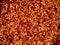 Crushed red chilli pepper used as background. Cayenne pepper, dried chili pepper flakes. It is a popular spicy condiment