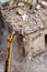 Crushing brick wall, building demolition with an excavator.