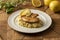 Crusted white tilapia fish with risotto on white plate with a blurred background