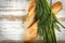 Crusty fresh seasoned baguette with sesame with fresh herbs on rustic wooden background