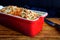 Crusty onion, garlic and cheese beer bread in red baking dish