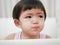 Crying Asian baby girl with tears, as she doesn`t want to go to bed
