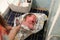 Crying baby when swaddling. A newborn 1 week old baby being examined by a pediatrician