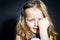 Crying blond little girl with focus on her tears