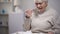 Crying elderly lady eating dinner, suffering from loneliness in old age, closeup