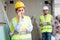 Crying female builder at construction site with displeased foreman