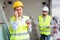 Crying female builder standing at construction site with banknotes in hands