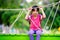 Crying little asian girl sitting alone on a playground