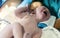 Crying newborn baby boy still with umbilical cord