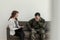 Crying soldier in green uniform during consultation with psychologist