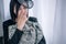 Crying woman holding military clothing at home