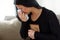 Crying woman with photo frame at funeral day