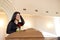 Crying woman with red rose and coffin at funeral