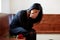 Crying woman with red rose at funeral in church