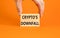 Crypto downfall symbol. Concept words Cryptos downfall on wooden blocks. Beautiful orange table orange background. Businessman