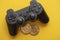 Crypto gaming concept. Video game controller with a bitcoin cryptocurrency coin